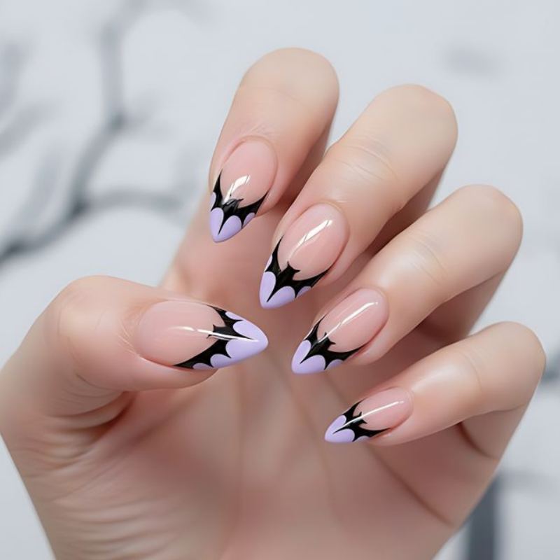Black bat silhouettes on orange halloween nail background