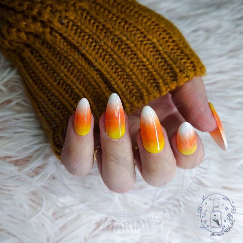 Candy corn striped halloween nail designs in orange yellow white