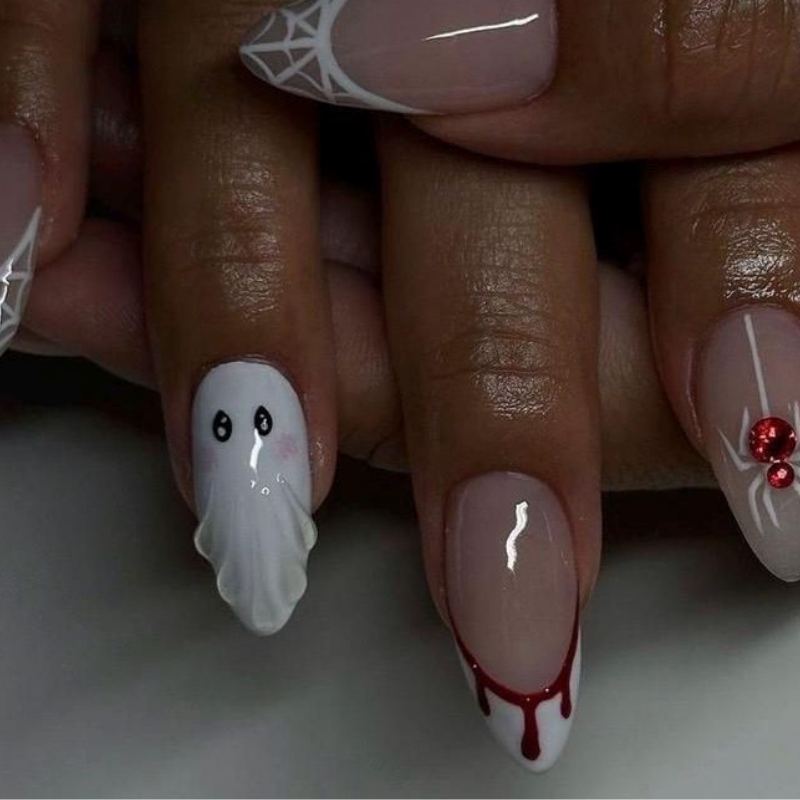 Delicate cobweb pattern on french tip halloween nails