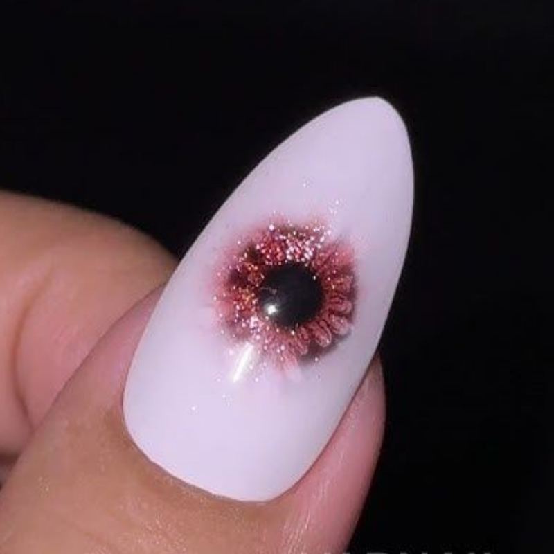 Blue evil eye design on white halloween nails