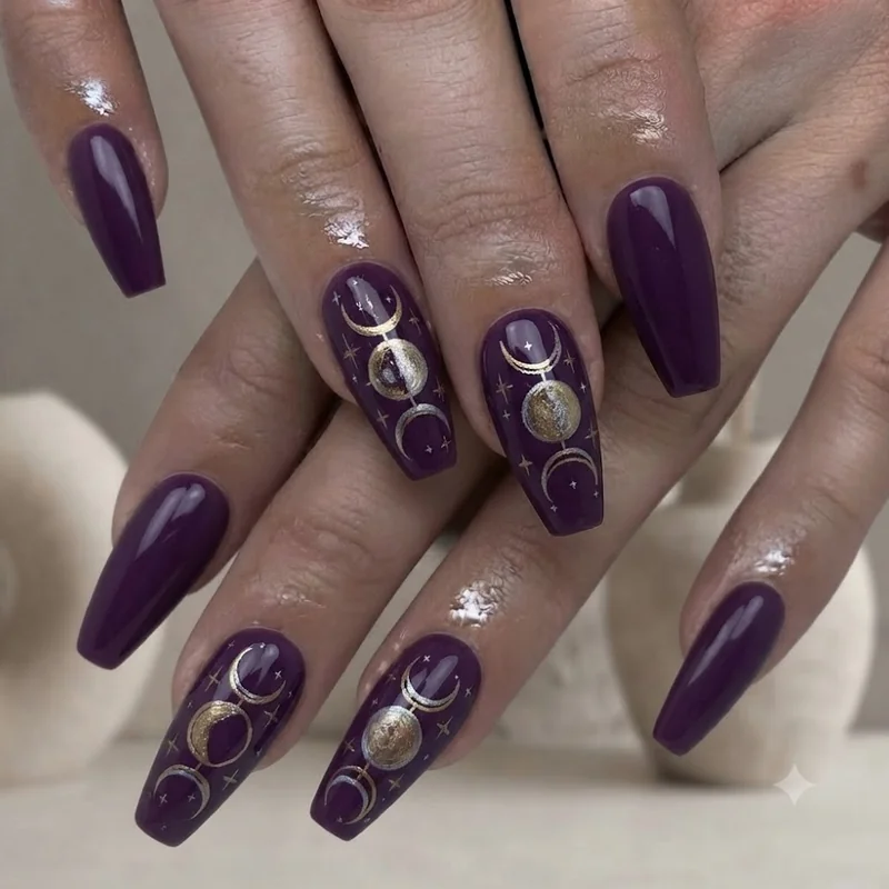 Witchy celestial moon phase halloween nail art design in deep purple manicure