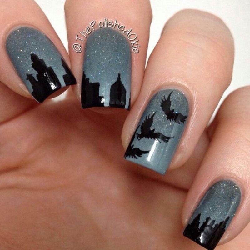 Spooky haunted house silhouette on orange halloween nails