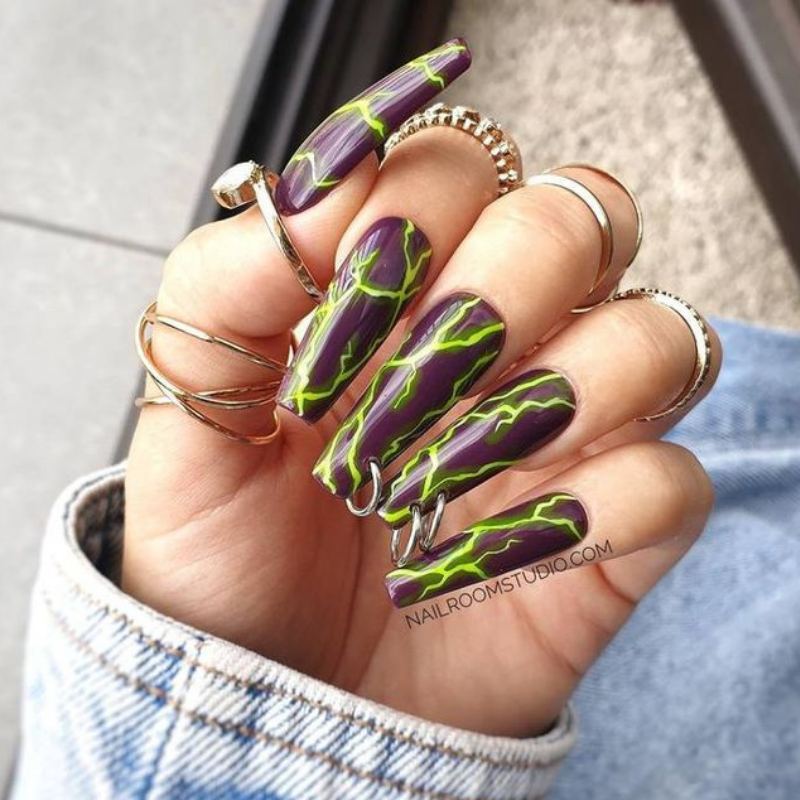Electric purple lightning bolts on black halloween nails