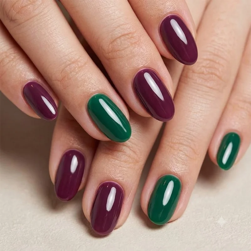 Glossy jewel tone dark moody manicure in plum and emerald with warm undertones