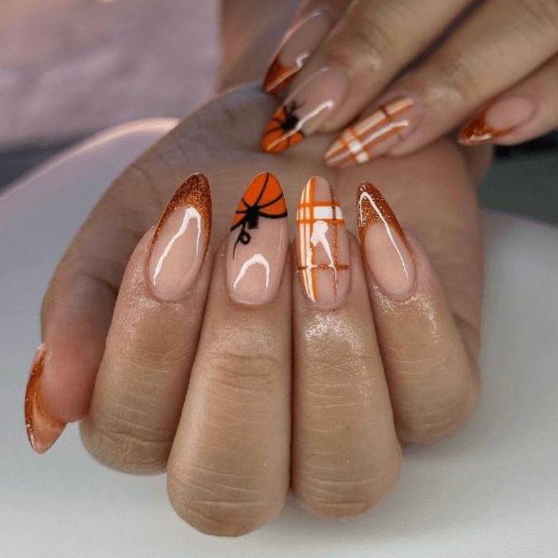 Orange and black plaid pattern on halloween nails