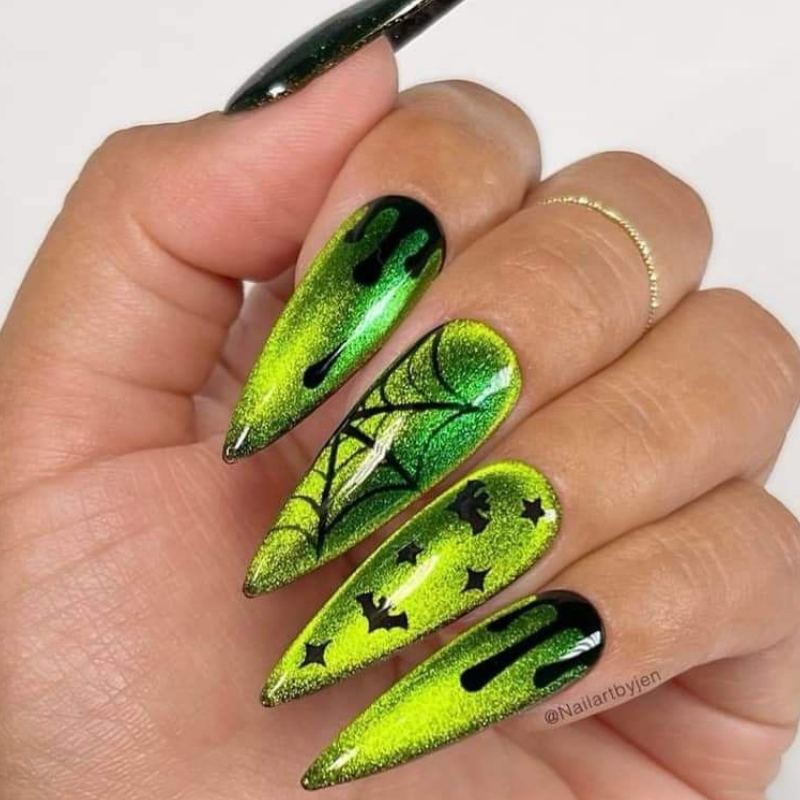 Green poison bottle design on black halloween nails