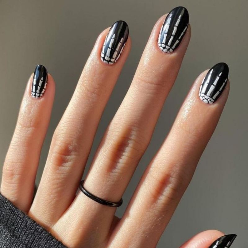 Skeleton bone details painted on black halloween nails