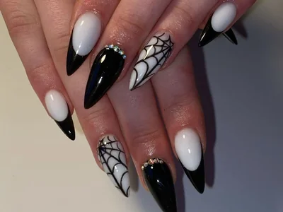 Fall 2025 elegant Halloween nails in black with minimalist spider web line art design sophisticated festive