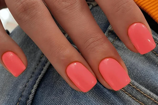 Summer 2025 vacation proof gel nails in bright coral with pool resistant top coat durable beach ready
