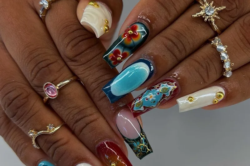 Summer 2025 tropical maximalist nail art featuring palm trees pineapples and ocean waves bright colorful design